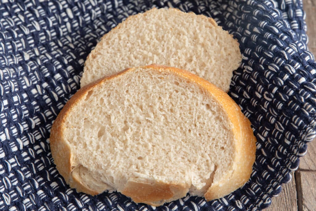 Two slices of bread on a blue napkin.