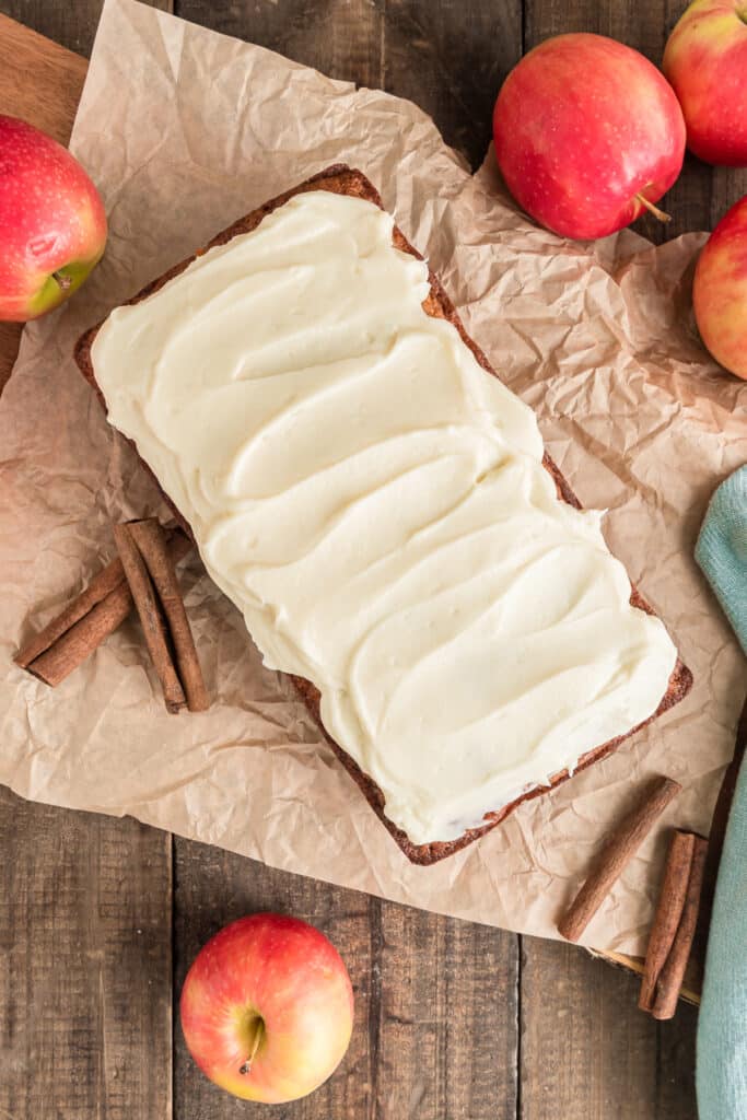 Frosted apple bread on brown paper.