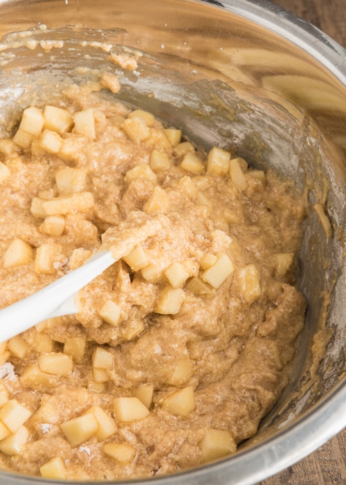 The apple mixture in the batter in the bowl.