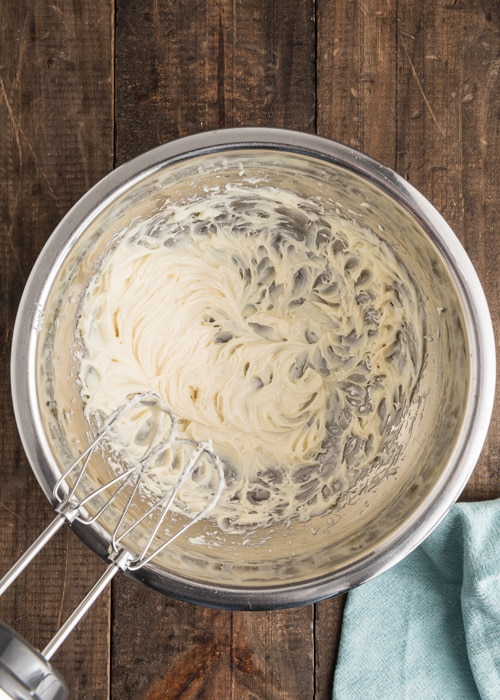 The frosting mixed in a silver bowl.