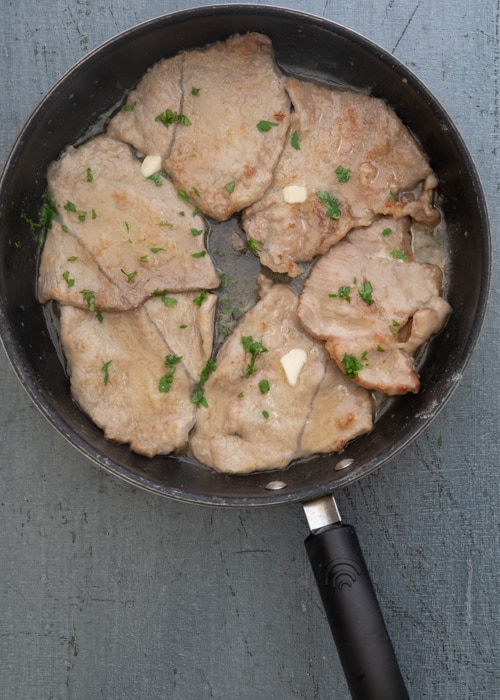 The veal with butter in the pan.