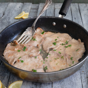 Veal piccata in a frying pan.