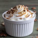 Maple mousse with syrup in a white bowl.