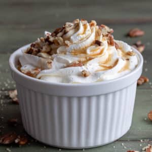 Maple mousse with syrup in a white bowl.
