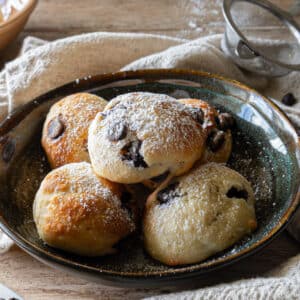 Ricotta cookies on a black plate.