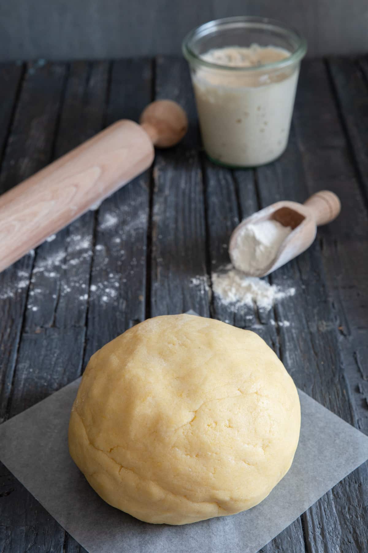 Pie dough on a wooden board.