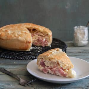 Easter pie with a slice cut on a white plate.
