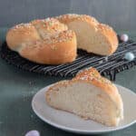 Easter bread with a slice cut on a white plate.