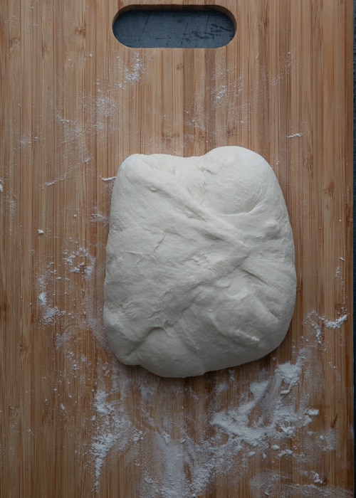 Folding the dough on a board.