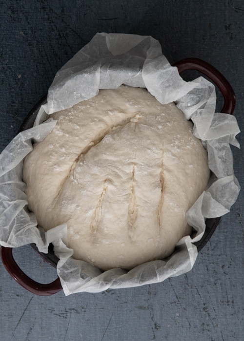The dough risen and scored.