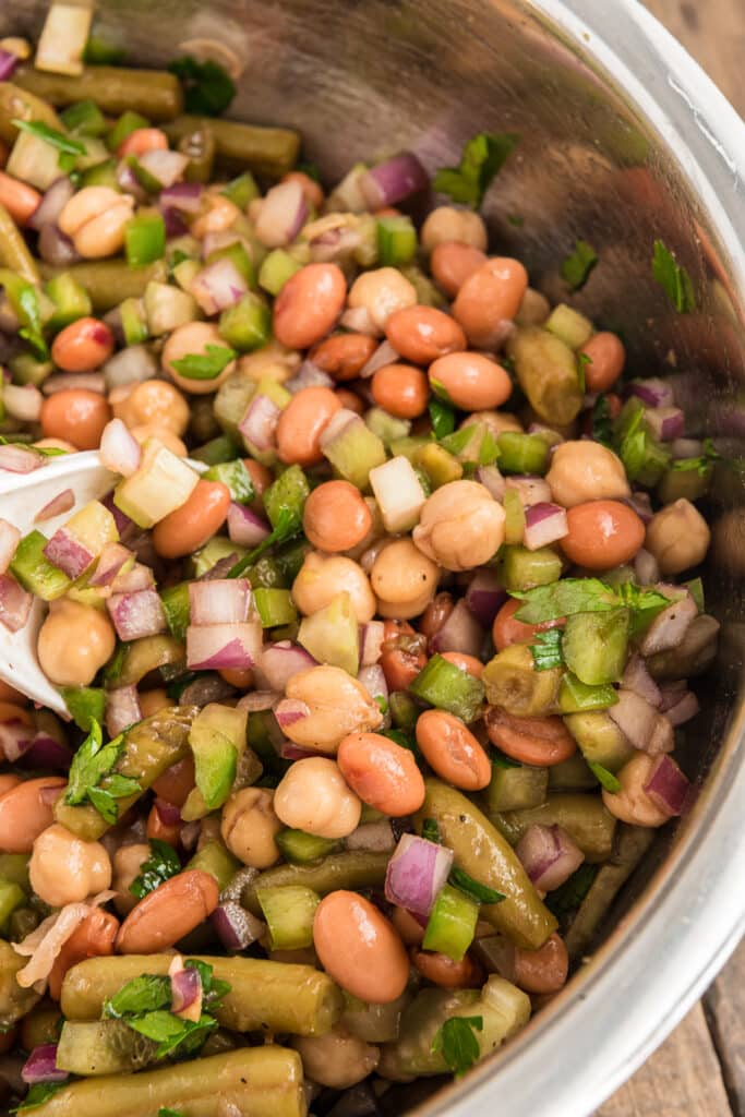 The bean salad in a silver bowl.