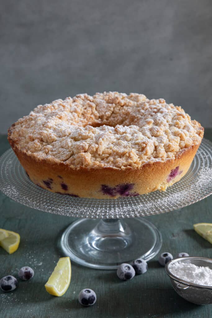 Blueberry cake on a glass stand.
