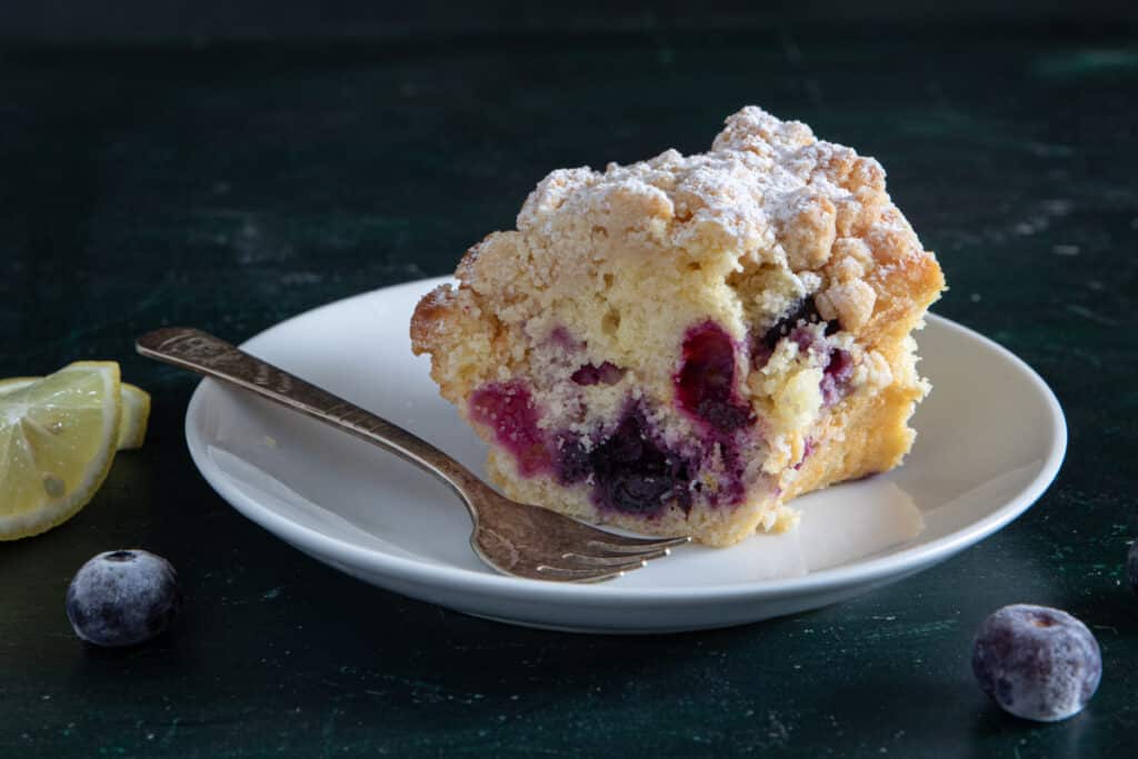 A slice of cake on a white plate.