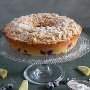 Blueberry cake on a glass stand.