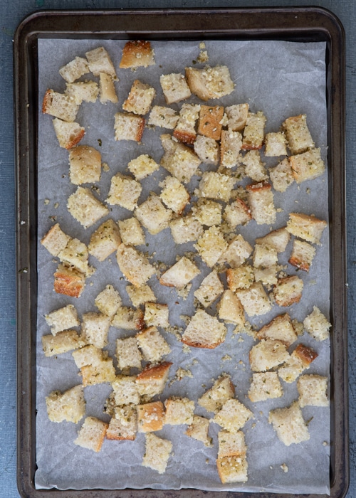 The croutons on a baking sheet before baking.