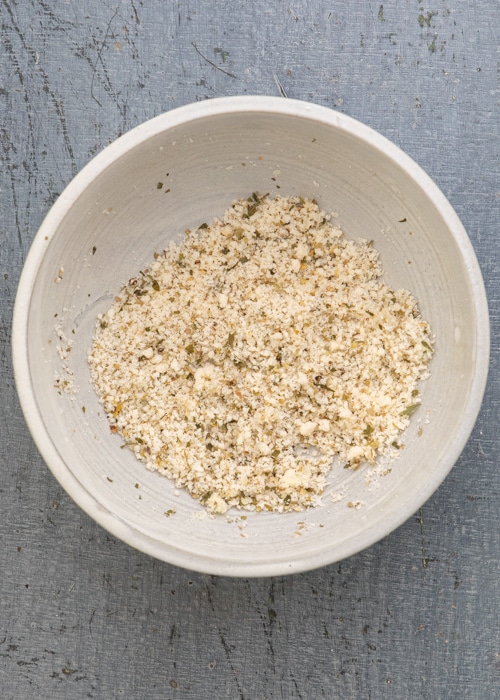 Mixing the spices in a white bowl.