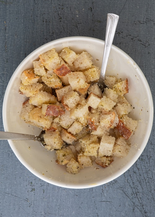 The bread added to the bowl and tossed.