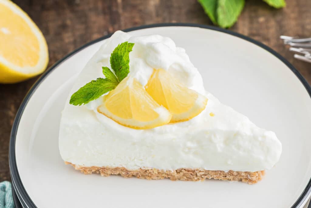 A slice of lemon pie on a white plate.