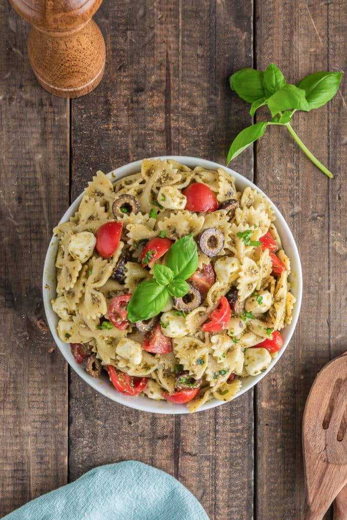 Pesto pasta salad in a white bowl.