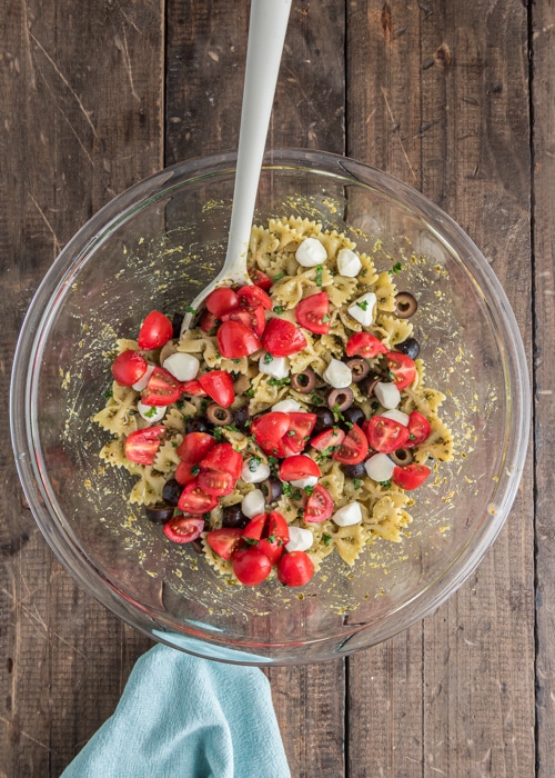 Adding the remaining ingredients to the pasta.