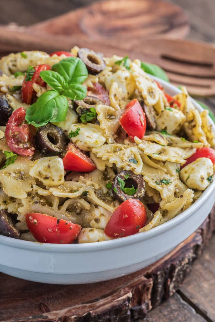 Pesto pasta salad in a white bowl.