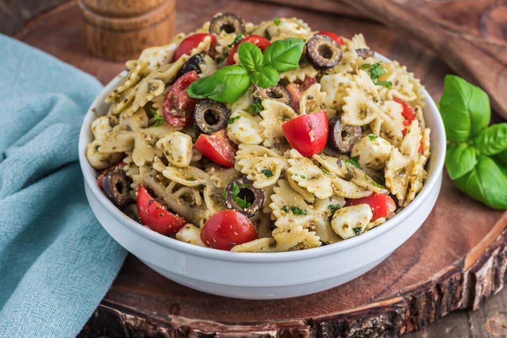Pasta salad in a white bowl.