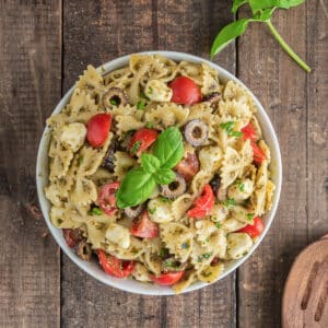 Pasta salad in a white bowl.