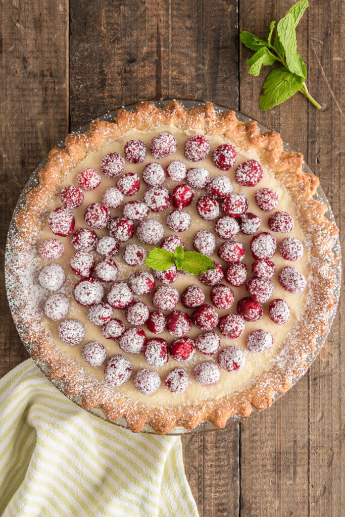 Raspberry crostata on a wooden board.