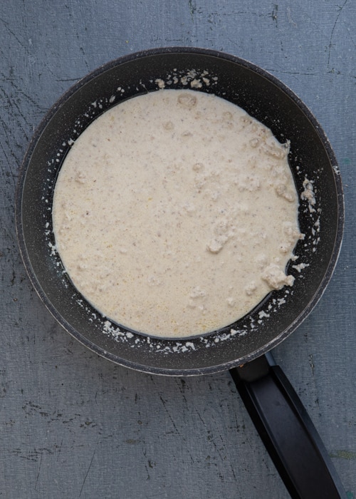 Making the sauce in a black pan.