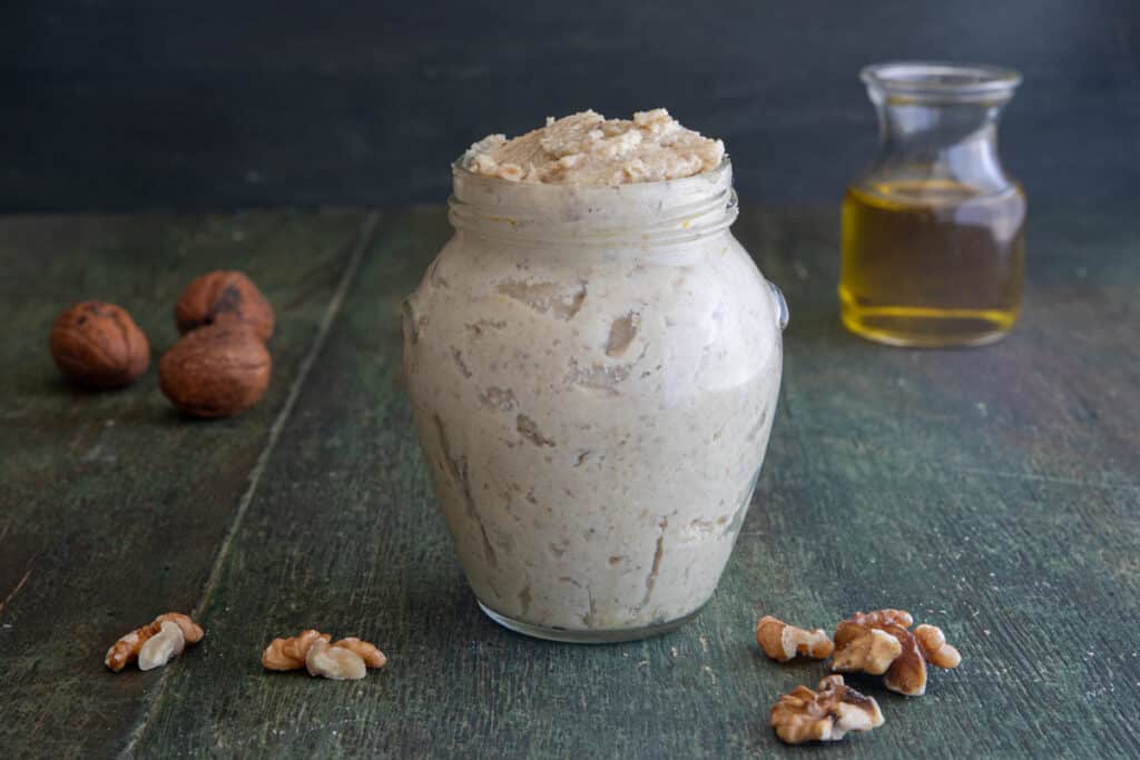Walnut pesto in a glass jar.