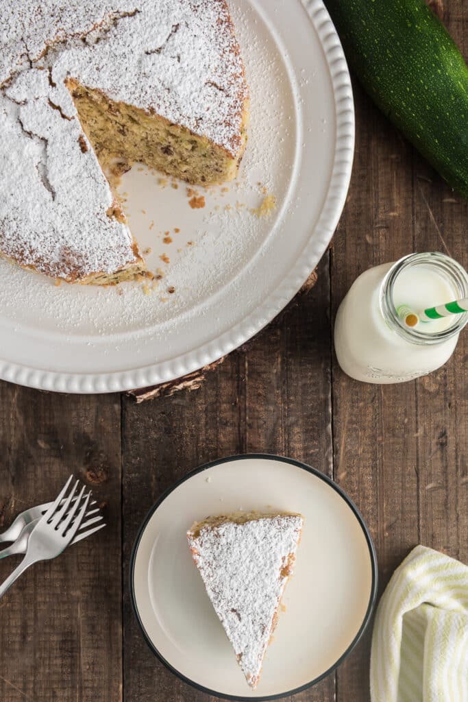 Cake on a white plate and a slice on a small white plate.
