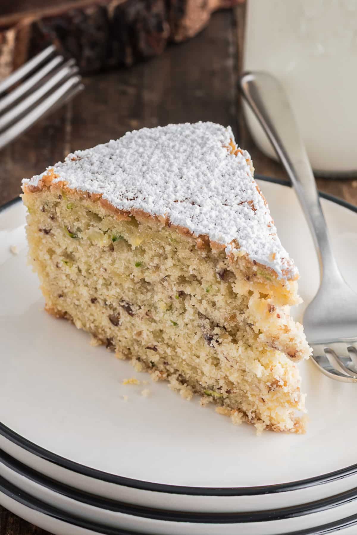 A slice of zucchini cake on a white plate.