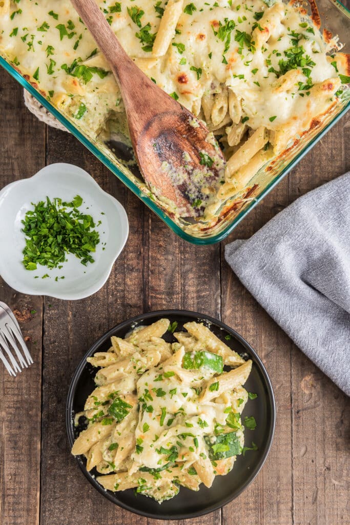 Zucchini pasta in the pan and some on a black plate.