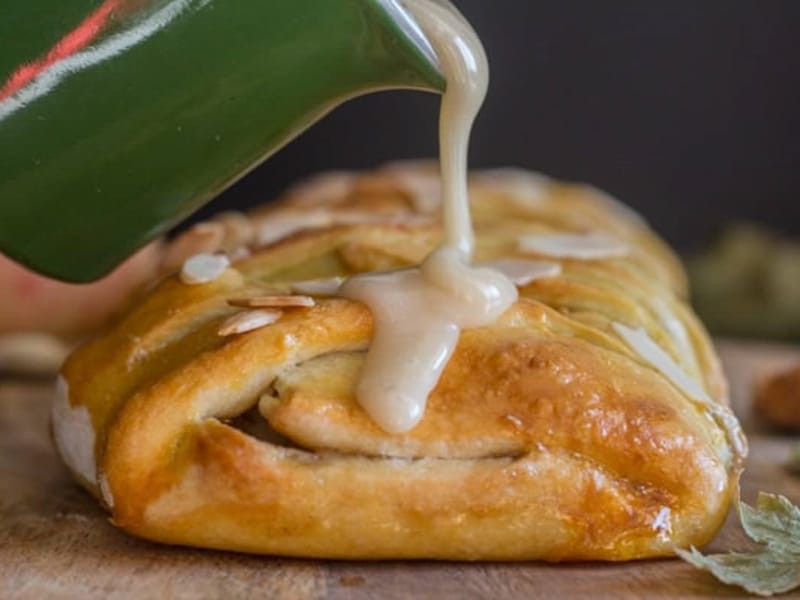 Pouring glaze on the cinnamon apple strudel.