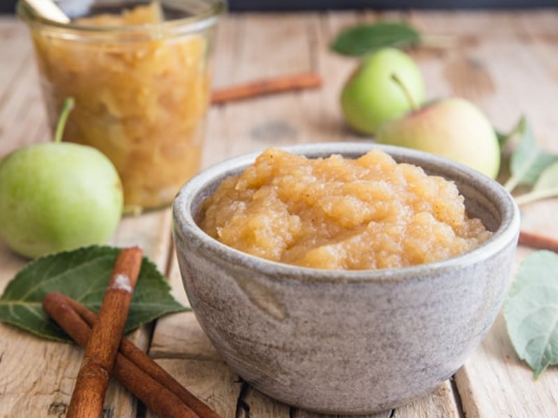 Applesauce in a jar and in a grey bowl.