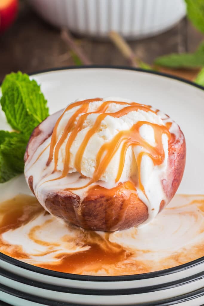 Caramelized peach on a plate with ice cream.