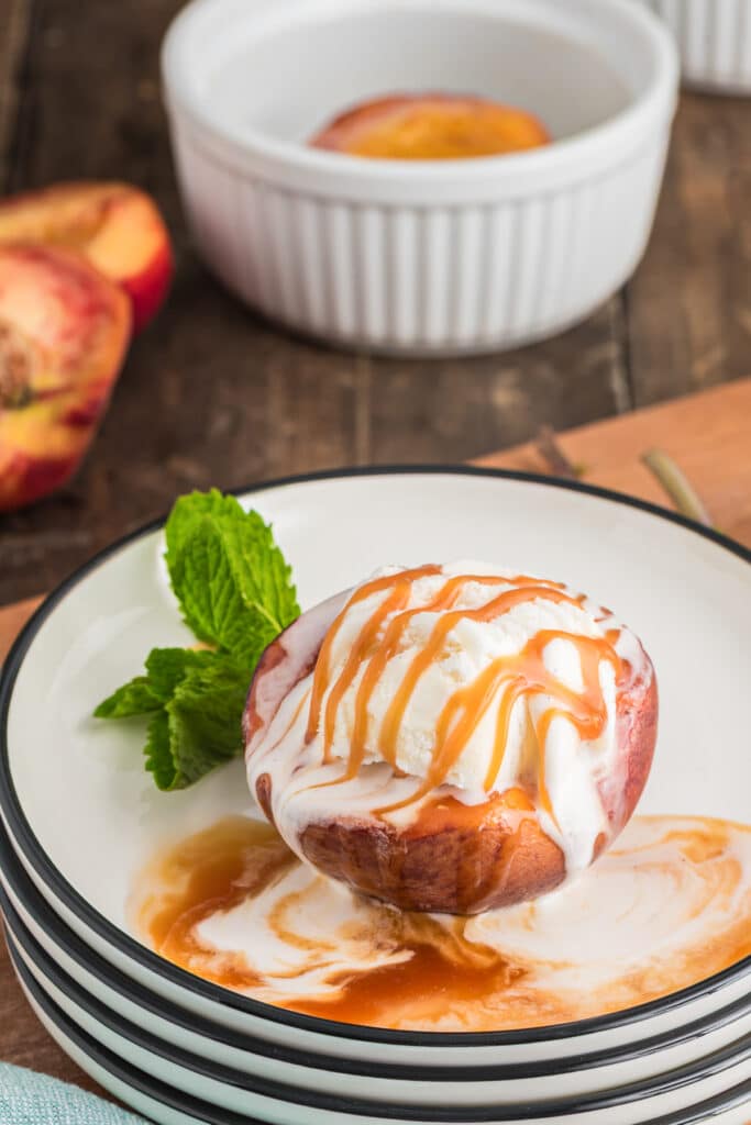 Baked peaches, one with ice cream.