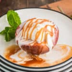 A baked peach with vanilla ice cream.