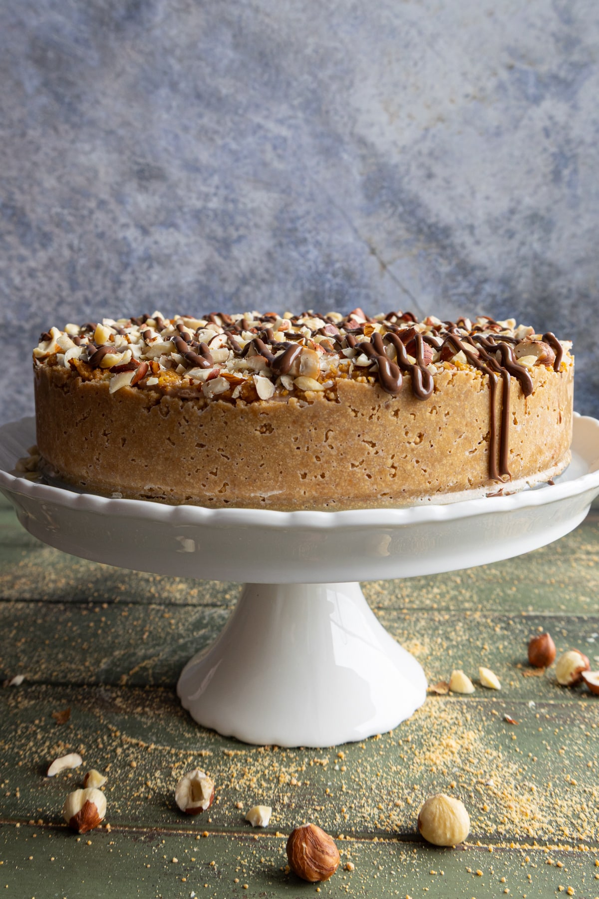 No bake hazelnut cake on a white cake stand.
