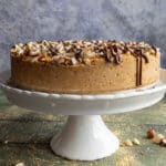 No bake hazelnut cake on a white cake stand.