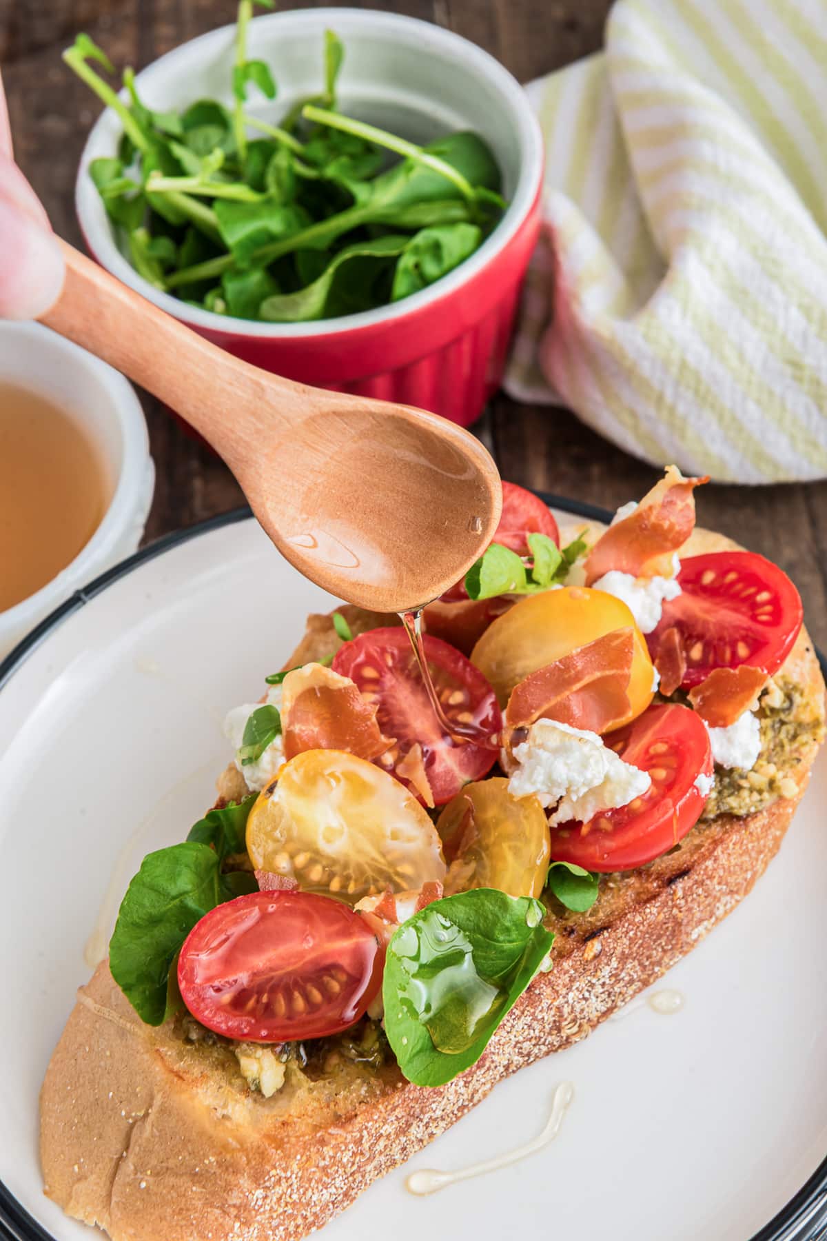 Drizzling oil on the bruschetta.