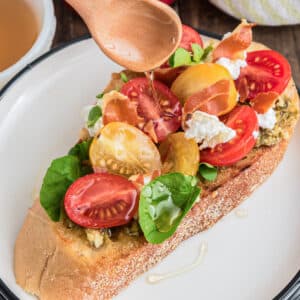 Drizzling oil on the bruschetta.