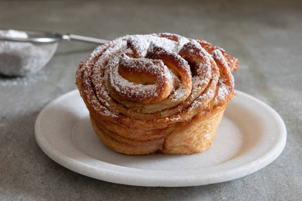 A cruffin on a white plate.
