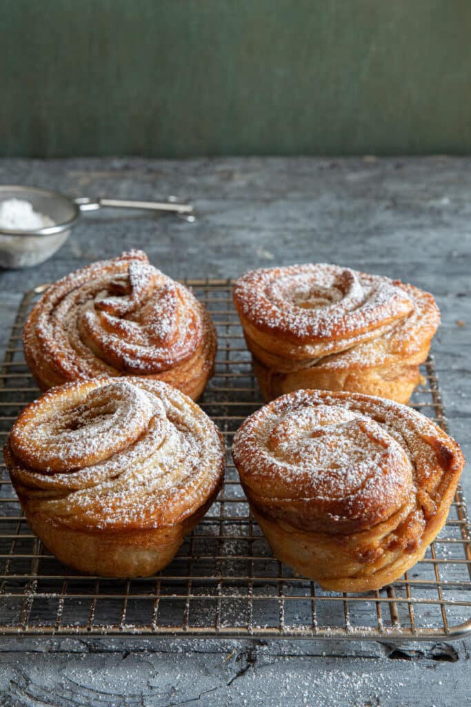 Cruffins on a wire rack.