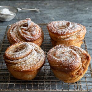 Cruffins on a wire rack.