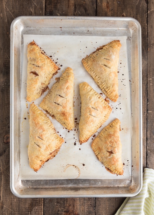 Baked hand pies on a baking sheet.
