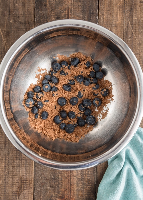 The blueberries and sugar in a bowl.
