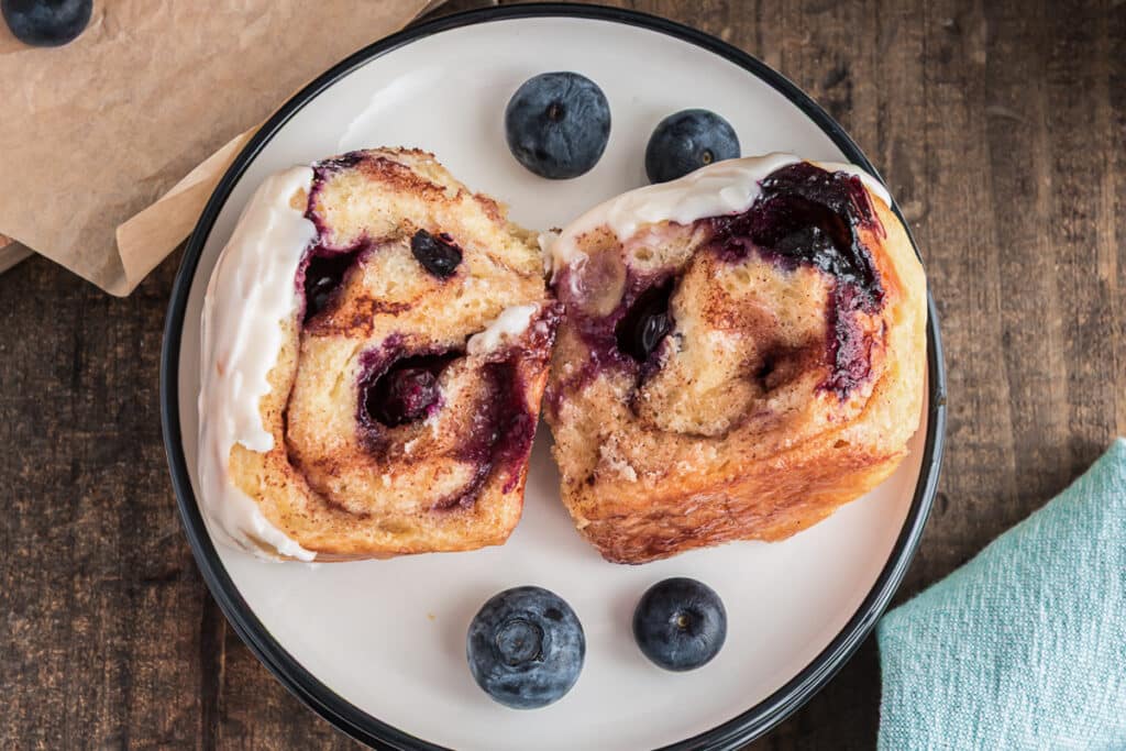 A slice of blueberry bread on a white plate.