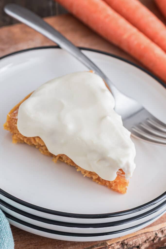 A slice of carrot cake on a white plate.