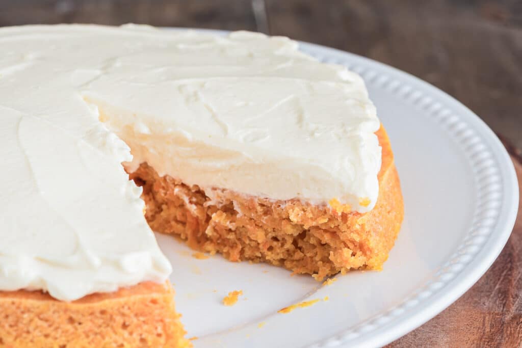 Carrot cake on a white plate.